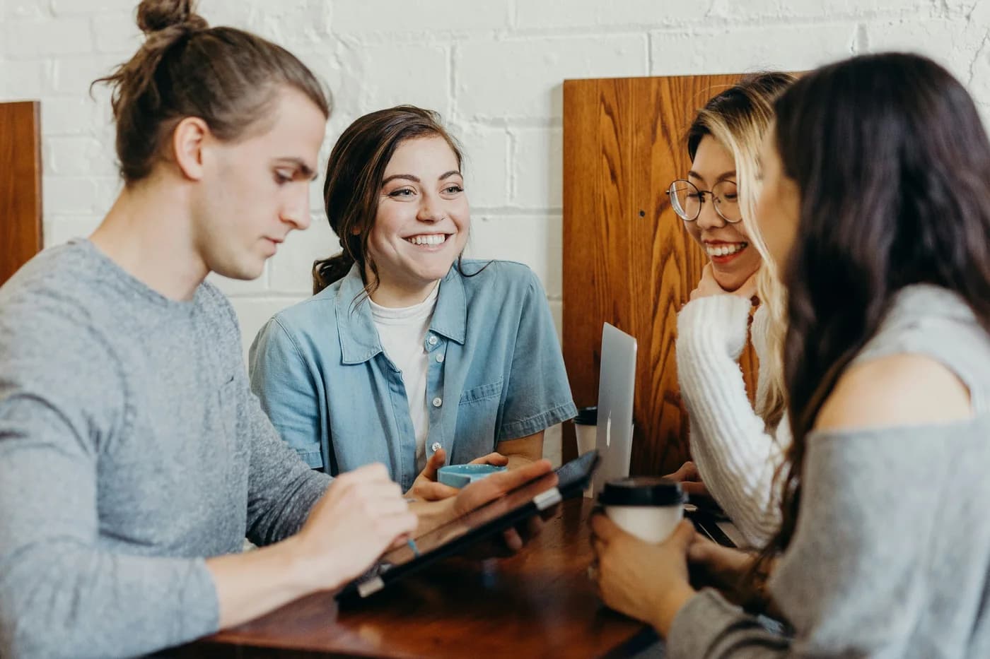 Colleagues talking together around a table